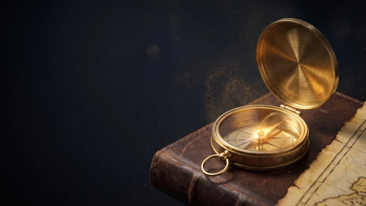 An open gold compass resting on an old map