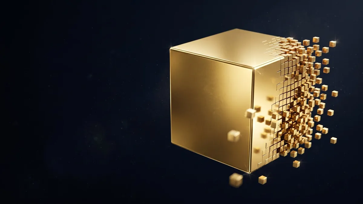 A solid gold cube breaking into small tokens
